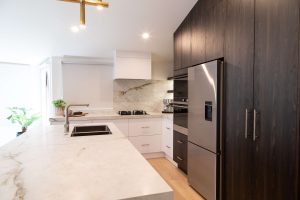 Nest Interiors & Design - Sage Doors Timbalook Rangitoto and White kitchen with island