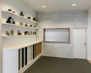 Sage Doors commercial servery roller door anodized aluminium closed in office space with Textaura Sophie Marble wall